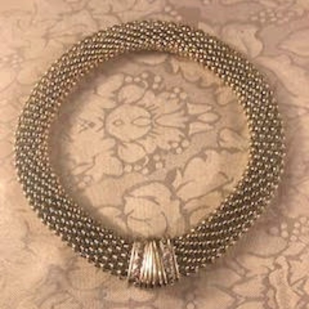 Magnetic Closure secures this eye catching silver tone necklace, 1" x 18"